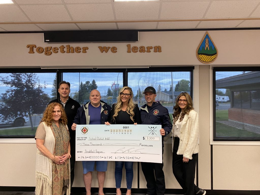 Photo of members of the district, Kim from Sand and Stone Jewelry, and members of the FSJ Firefighters Charitable Fund presenting a $3000 cheque to the SD60 Meals Program